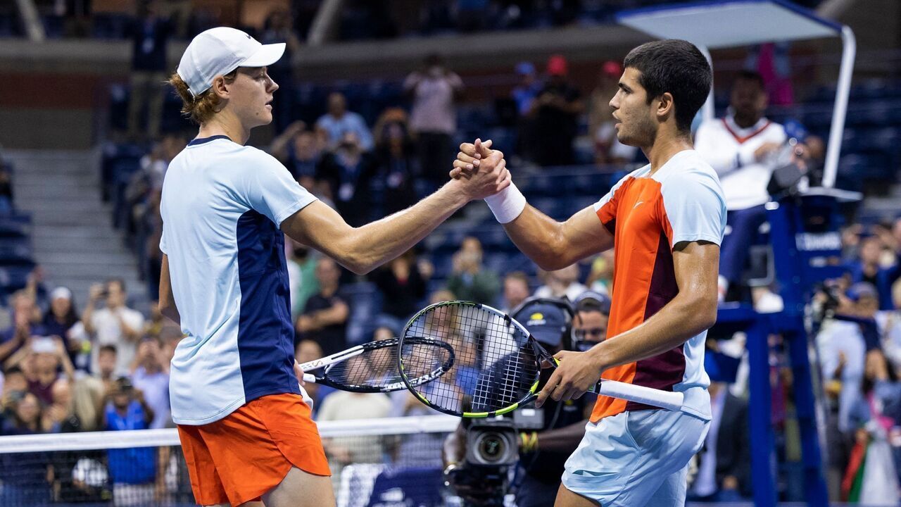 Spain's Carlos Alcaraz (R) greets Italy's Jannik Sinner at the net after winning their 2022 US Open Tennis tournament men's singles quarter-final match against at the USTA Billie Jean King National Tennis Center in New York, on early September 8, 2022.
