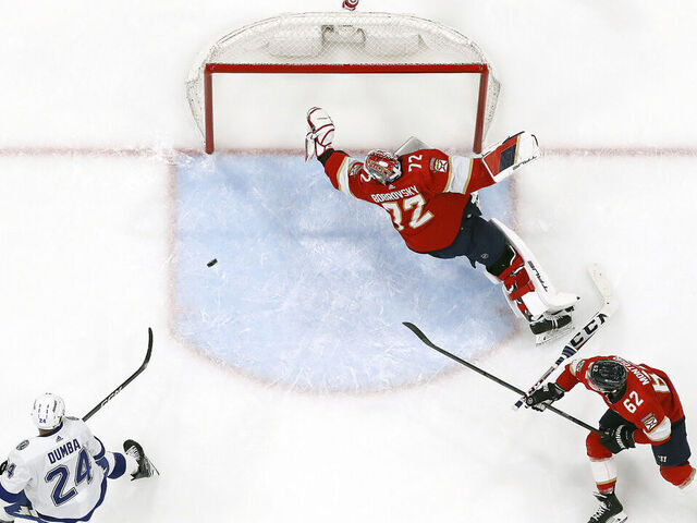 SUNRISE, FLORIDA - APRIL 23: Goaltender Sergei Bobrovsky #72 of the Florida Panthers defends the net with the help of teammate Brandon Montour #62 against Mathew Dumba #24 of the Tampa Bay Lightning in Game Two of the First Round of the 2024 Stanley Cup Playoffs at the Amerant Bank Arena on April 23, 2024 in Sunrise, Florida.