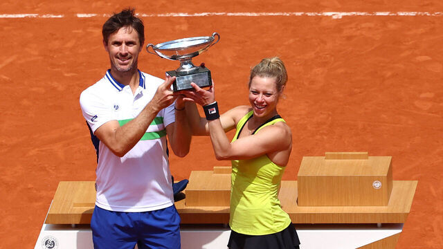 France's Edouard Roger-Vasselin (L) and Germany's Laura Siegemund hold the trophy after winning against US' Desirae Krawczyk and Britain's Neal Skupski at the end of their mixed doubles final match on Court Philippe-Chatrier on day twelve of the French Open tennis tournament at the Roland Garros Complex in Paris on June 6, 2024.