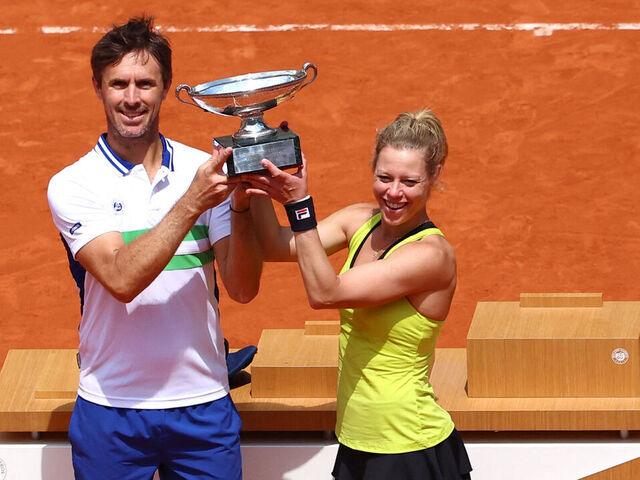 France's Edouard Roger-Vasselin (L) and Germany's Laura Siegemund hold the trophy after winning against US' Desirae Krawczyk and Britain's Neal Skupski at the end of their mixed doubles final match on Court Philippe-Chatrier on day twelve of the French Open tennis tournament at the Roland Garros Complex in Paris on June 6, 2024.