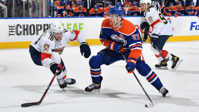 EDMONTON, CANADA - DECEMBER 16: Connor McDavid #97 of the Edmonton Oilers drives the net during the game against Steven Lorentz #18 of the Florida Panthers at Rogers Place on December 16, 2023, in Edmonton, Alberta, Canada.