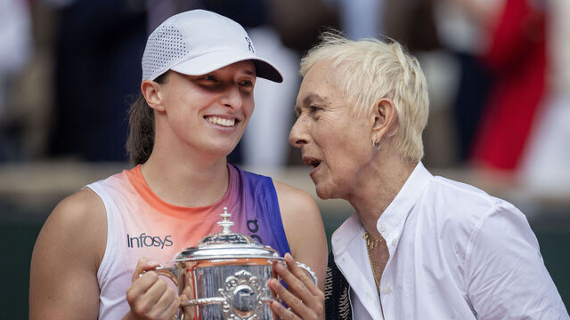 PARIS, FRANCE - June 08: Iga Swiatek of Poland shares a moment with Martina Navratilova as she holds the winners trophy after her victory against Jasmine Paolini of Italy during the Women's Singles Final on Court Philippe-Chatrier at the 2024 French Open Tennis Tournament at Roland Garros on June 8th, 2024, in Paris, France.