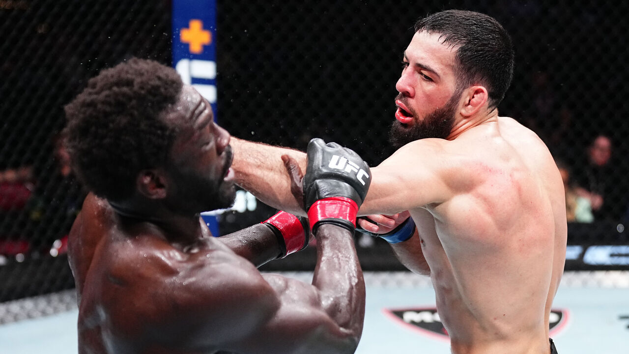 LOUISVILLE, KENTUCKY - JUNE 08: (R-L) Nassourdine Imavov of Russia punches Jared Cannonier in a middleweight fight during the UFC Fight Night event at KFC YUM! Center on June 08, 2024 in Louisville, Kentucky.