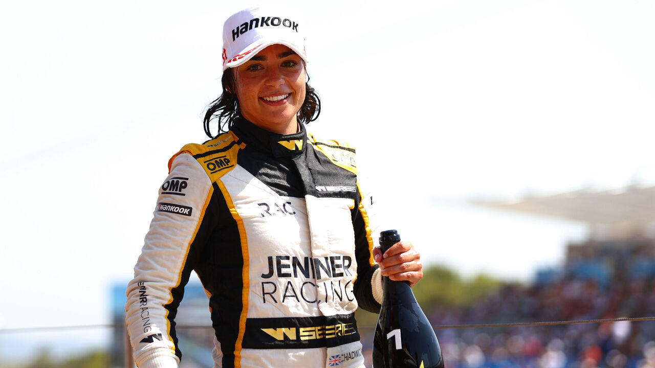 LE CASTELLET, FRANCE - JULY 23: Race winner Jamie Chadwick of Great Britain and Jenner Racing (55) celebrates on the podium during the W Series Round 4 race at Circuit Paul Ricard on July 23, 2022 in Le Castellet, France.