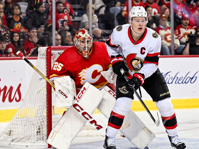 CALGARY, AB - JANUARY 09: Calgary Flames Goalie Jacob Markstrom (25) tries to look past Ottawa Senators Left Wing Brady Tkachuk (7) during the first period of an NHL game between the Calgary Flames and the Ottawa Senators on January 9, 2024, at the Scotiabank Saddledome in Calgary, AB.