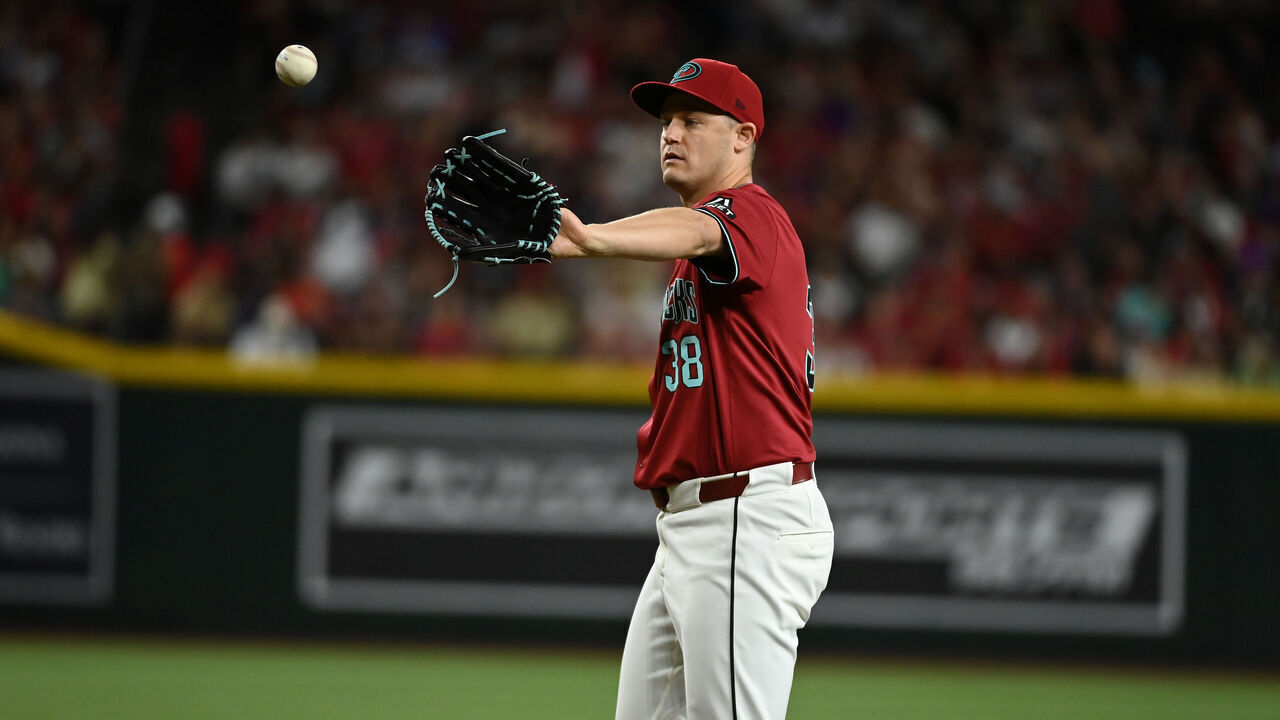 PHOENIX, ARIZONA - MAY 25: Paul Sewald #38 of the Arizona Diamondbacks catches a throw from home plate against the Miami Marlins at Chase Field on May 25, 2024 in Phoenix, Arizona.