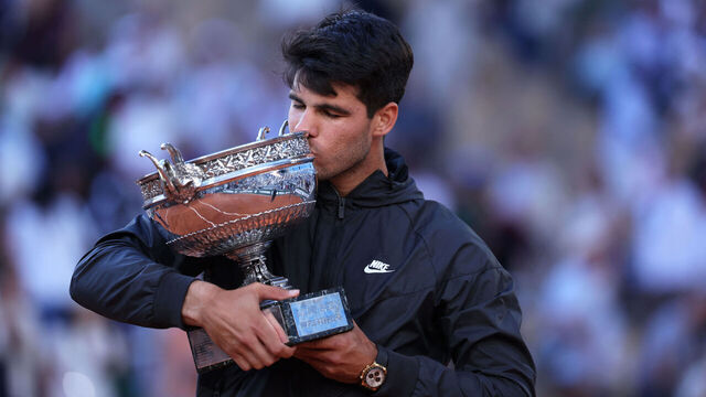 Spain's Carlos Alcaraz kisses the trophy after winning against Germany's Alexander Zverev in the men's singles final match on Court Philippe-Chatrier on day fifteen of the French Open tennis tournament at the Roland Garros Complex in Paris on June 9, 2024.