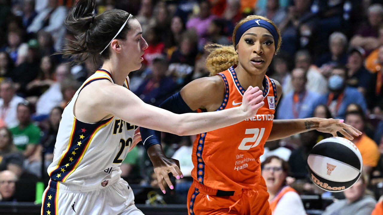 UNCASVILLE, CONNECTICUT - JUNE 10: DiJonai Carrington #21 of the Connecticut Sun drives to the basket against Caitlin Clark #22 of the Indiana Fever during the second half at the Mohegan Sun Arena on June 10, 2024 in Uncasville, Connecticut.