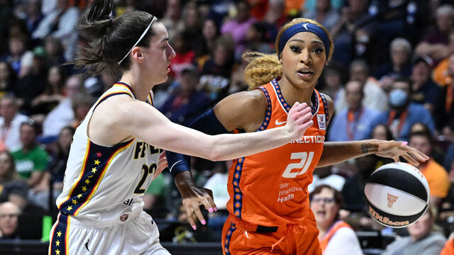 UNCASVILLE, CONNECTICUT - JUNE 10: DiJonai Carrington #21 of the Connecticut Sun drives to the basket against Caitlin Clark #22 of the Indiana Fever during the second half at the Mohegan Sun Arena on June 10, 2024 in Uncasville, Connecticut.