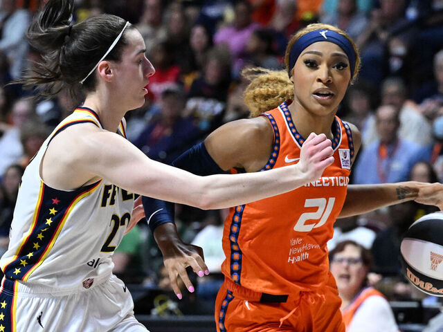 UNCASVILLE, CONNECTICUT - JUNE 10: DiJonai Carrington #21 of the Connecticut Sun drives to the basket against Caitlin Clark #22 of the Indiana Fever during the second half at the Mohegan Sun Arena on June 10, 2024 in Uncasville, Connecticut.