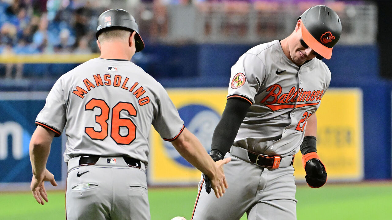 ST PETERSBURG, FLORIDA - JUNE 10: James McCann #27 of the Baltimore Orioles celebrates with third base coach Tony Mansolino #36 after hitting a home run in the third inning against the Tampa Bay Rays at Tropicana Field on June 10, 2024 in St Petersburg, Florida.