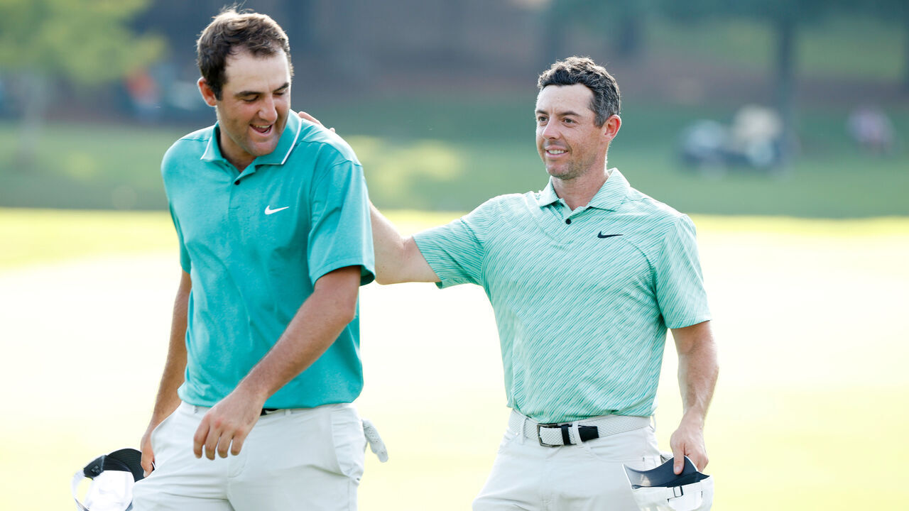 ATLANTA, GEORGIA - AUGUST 28: Scottie Scheffler of the United States congratulates Rory McIlroy of Northern Ireland on the 18th green after McIlroy won during the final round of the TOUR Championship at East Lake Golf Club on August 28, 2022 in Atlanta, Georgia.