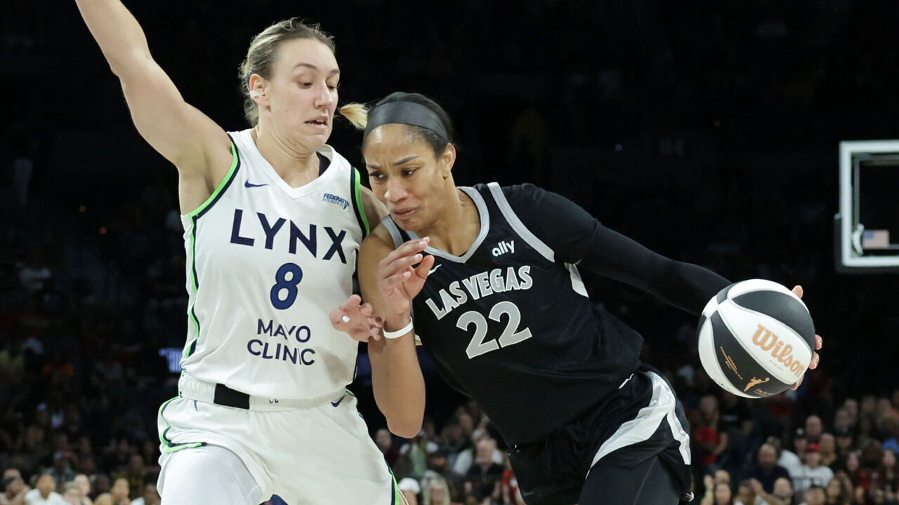 LAS VEGAS, NEVADA - JUNE 11: A'ja Wilson #22 of the Las Vegas Aces drives against Alanna Smith #8 of the Minnesota Lynx in the fourth quarter of their game at Michelob ULTRA Arena on June 11, 2024 in Las Vegas, Nevada. The Lynx defeated the Aces 100-86.
