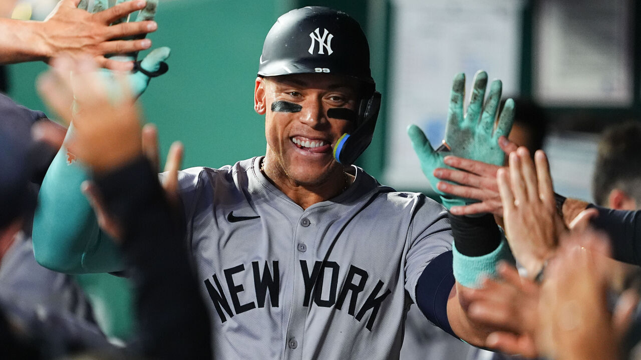 KANSAS CITY, MISSOURI - JUNE 11: Aaron Judge #99 of the New York Yankees celebrates with teammates after hitting a two-run home run against the Kansas City Royals during the seventh inning at Kauffman Stadium on June 11, 2024 in Kansas City, Missouri.