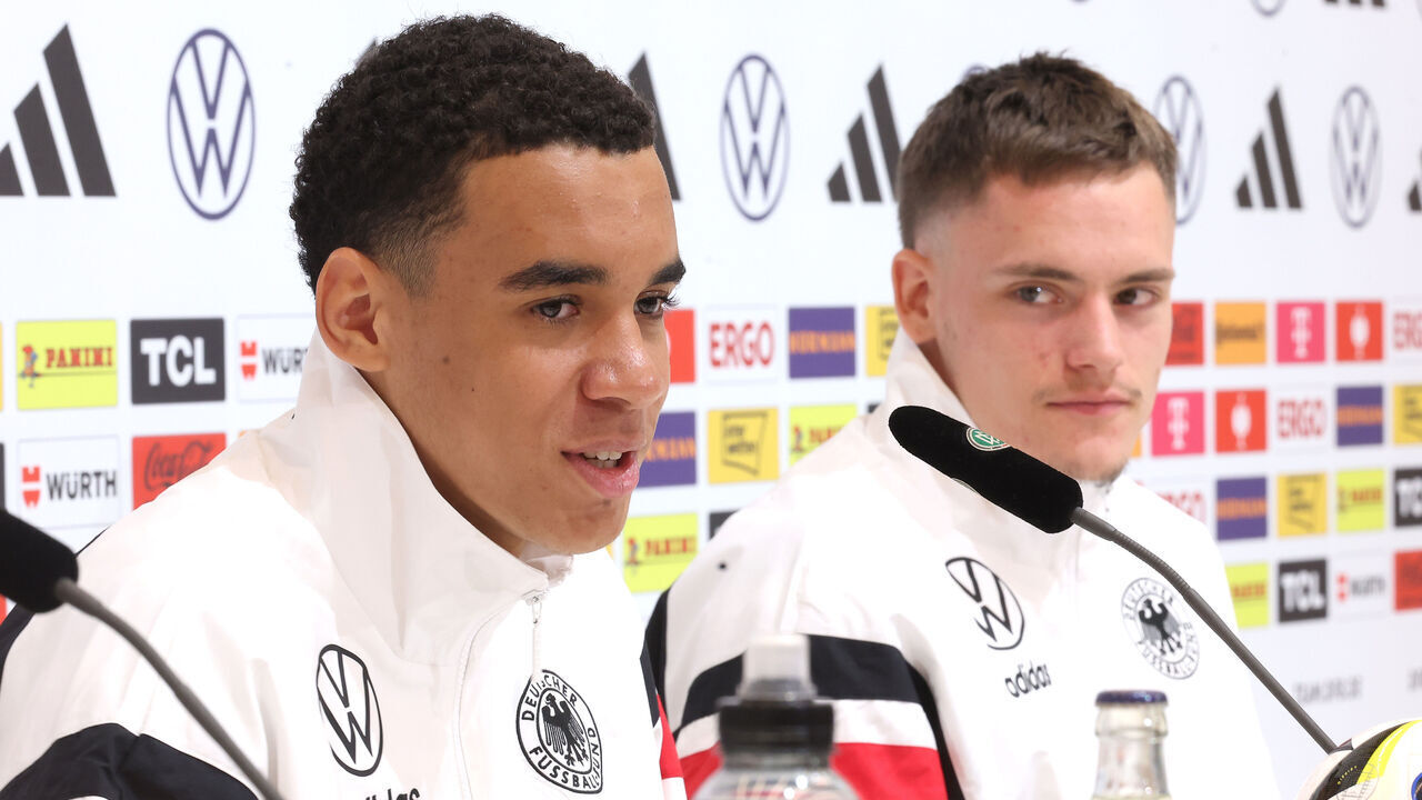 HERZOGENAURACH, GERMANY - JUNE 12: Jamal Musiala of Germany talks next to his team mate Florian Wirtz to the media during a press conference at adidas HQ Herzo-Base on June 12, 2024 in Herzogenaurach, Germany.
