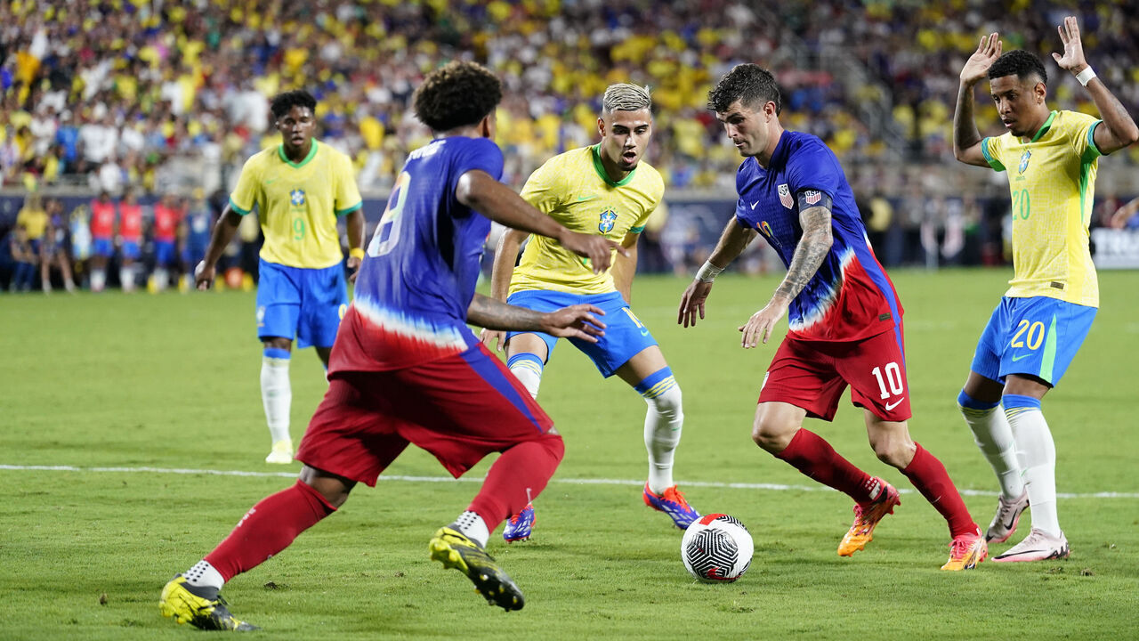 ORLANDO, FLORIDA - JUNE 12: Christian Pulisic #10 of the United States dribbles the ball against Andreas Pereira #19 of Brazil during the Continental Clasico 2024 game at Camping World Stadium on June 12, 2024 in Orlando, Florida.