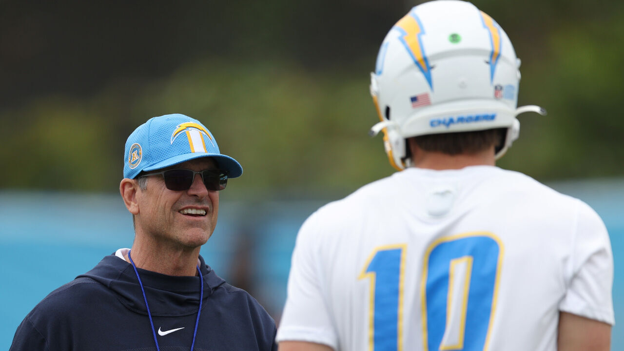 COSTA MESA, CALIFORNIA - MAY 20: Head coach Jim Harbaugh and quarterback Justin Herbert during a Los Angeles Chargers OTA offseason workout on May 20, 2024 in Costa Mesa, California.
