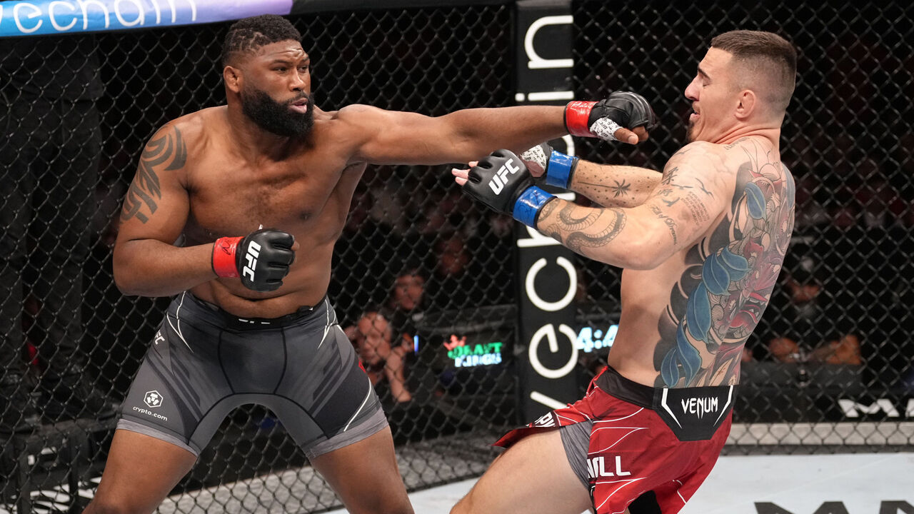 LONDON, ENGLAND - JULY 23: (L-R) Curtis Blaydes punches Tom Aspinall of England in a heavyweight fight during the UFC Fight Night event at O2 Arena on July 23, 2022 in London, England.