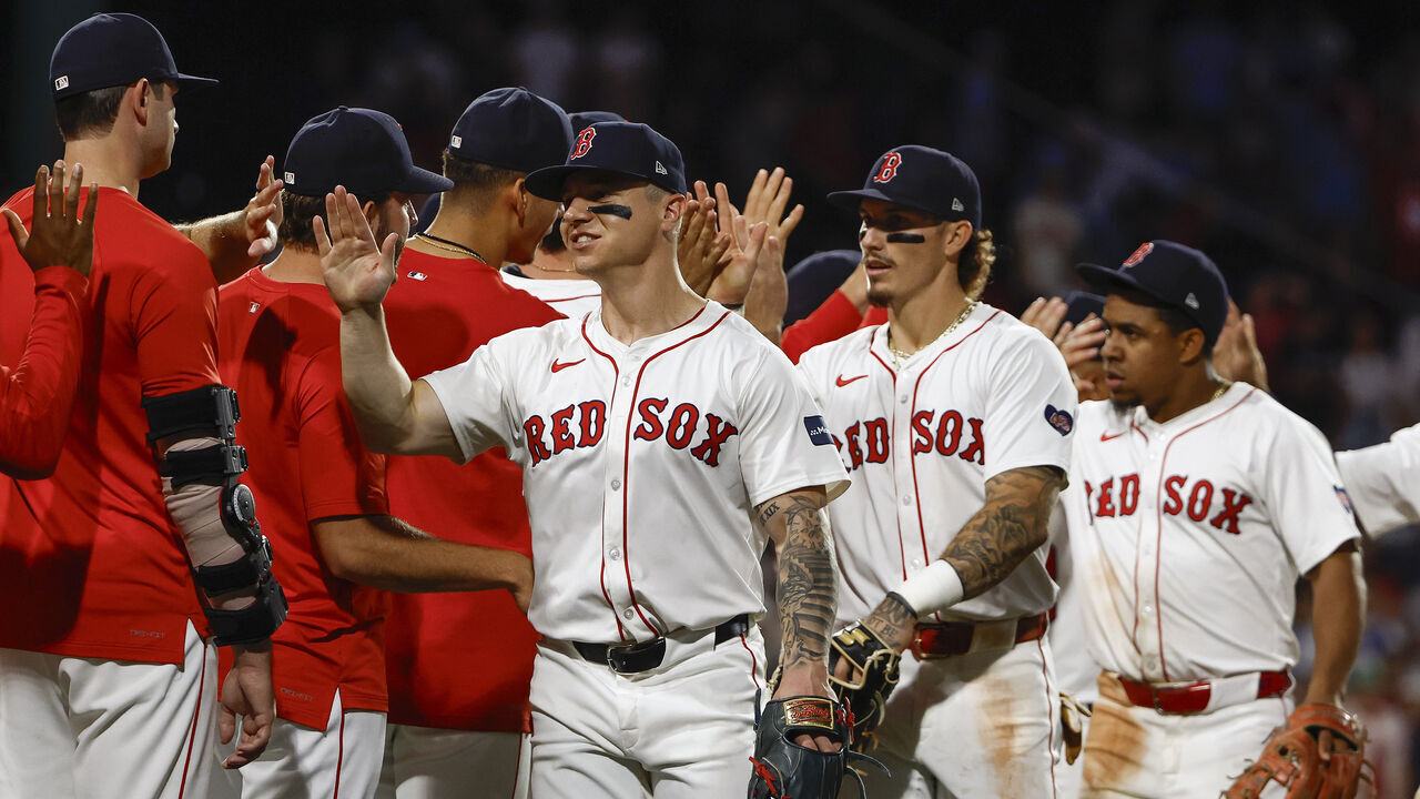 BOSTON, MA - JUNE 13: Tyler O'Neill #17 and Jarren Duran #16 of the Boston Red Sox lead the way as they are congratulated by teammates after their 9-3 win over the Philadelphia Phillies at Fenway Park on June 13, 2024 in Boston, Massachusetts.