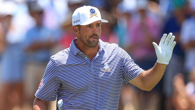PINEHURST, NORTH CAROLINA - JUNE 14: Bryson DeChambeau of The United States acknowledges the applause from the galleries after playing his second shot on the 18th hole during the second round of the 2024 U.S. Open on The No.2 Course at The Pinehurst Resort on June 14, 2024 in Pinehurst, North Carolina.