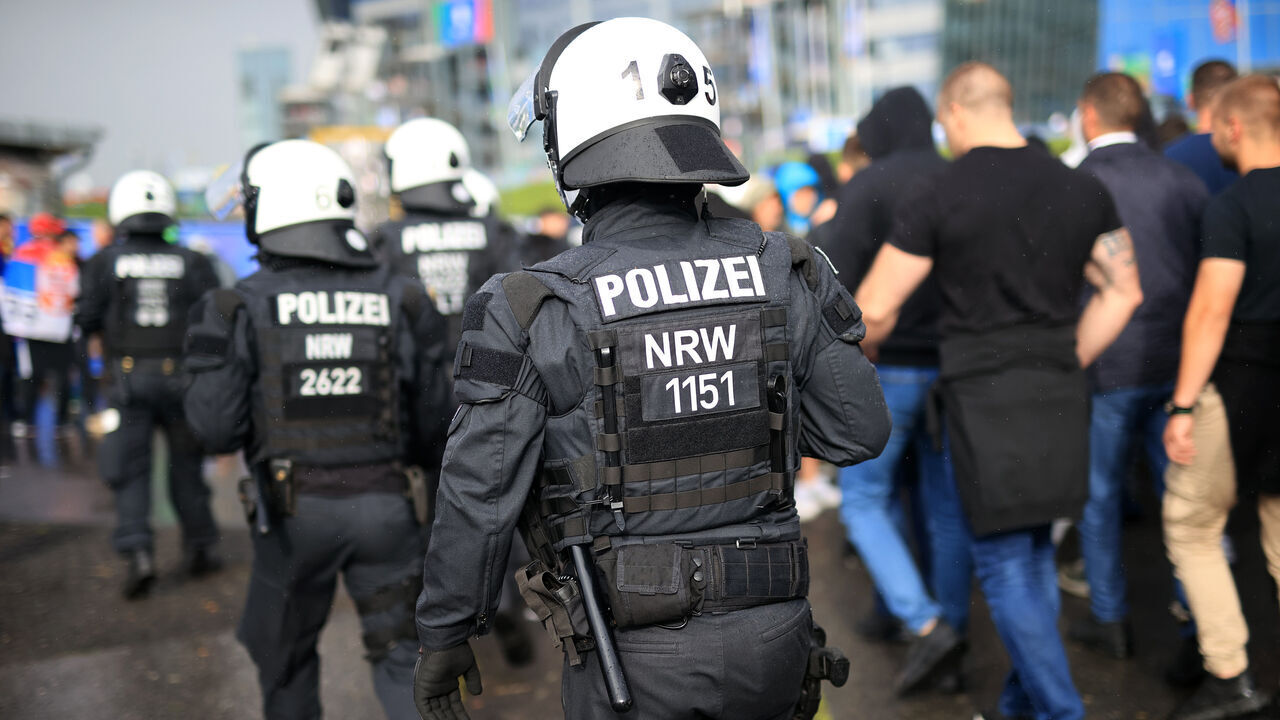 GELSENKIRCHEN, GERMANY - JUNE 16: Police officers escort the fans to the UEFA EURO 2024 group stage match between Serbia and England at Arena AufSchalke on June 16, 2024 in Gelsenkirchen, Germany.