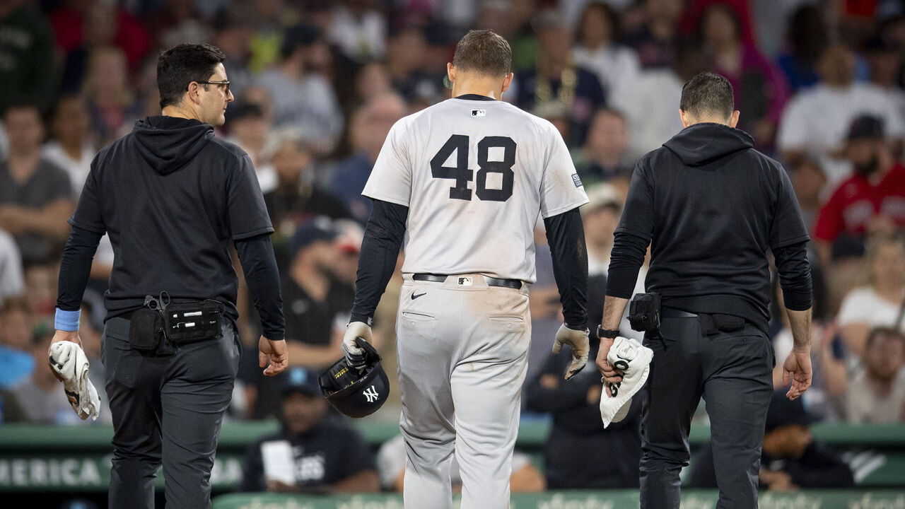 BOSTON, MA - JUNE 16: Anthony Rizzo #48 of the New York Yankees exits the game with trainers after a collision at first base during a game against the New York Yankees on June 16, 2024 at Fenway Park in Boston, Massachusetts.