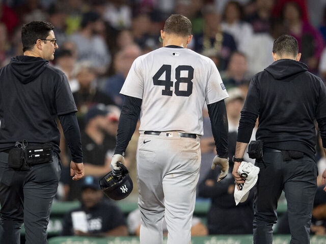 BOSTON, MA - JUNE 16: Anthony Rizzo #48 of the New York Yankees exits the game with trainers after a collision at first base during a game against the New York Yankees on June 16, 2024 at Fenway Park in Boston, Massachusetts.
