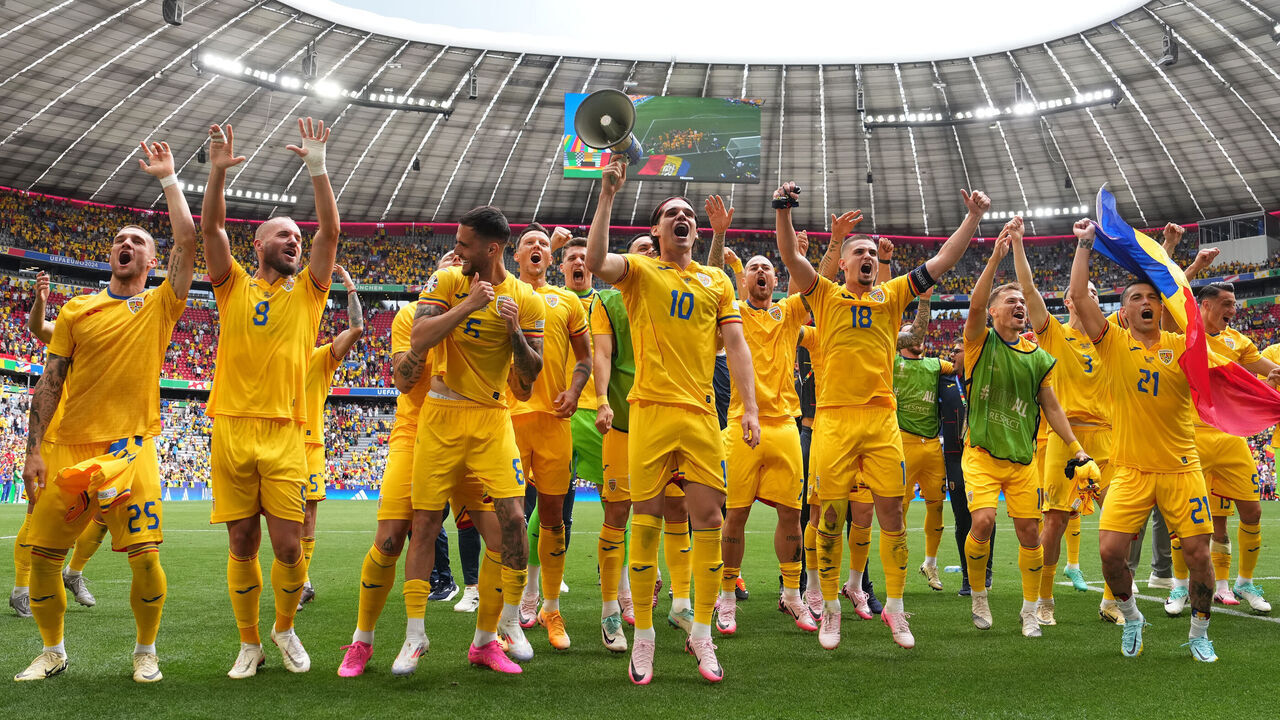 MUNICH, GERMANY - JUNE 17: A general view of the inside of the stadium as Ianis Hagi of Romania uses a megaphone as he celebrates victory with teammates as they acknowledge the fans after the UEFA EURO 2024 group stage match between Romania and Ukraine at Munich Football Arena on June 17, 2024 in Munich, Germany.