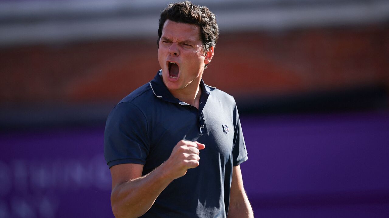 Canada's Milos Raonic celebrates after winning against Britain's Cameron Norrie during the men's singles round of 32 match at the cinch ATP tennis Championships at Queen's Club in west London on June 17, 2024.