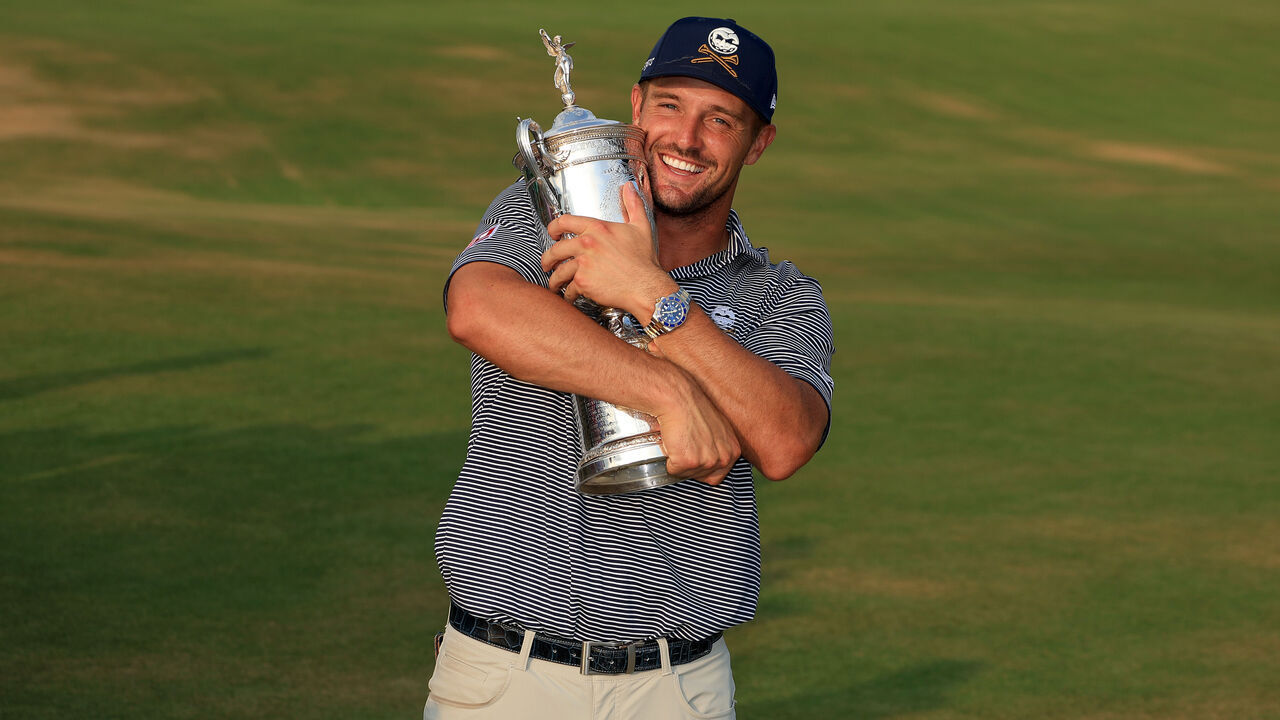 PINEHURST, NORTH CAROLINA - JUNE 16: Bryson DeChambeau of The United States cradles the U.S.Open trophy after his win in the final round of the 2024 U.S. Open Championship on the No.2 Course at The Pinehurst Resort on June 16, 2024 in Pinehurst, North Carolina.