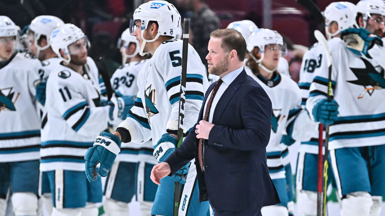 MONTREAL, CANADA - NOVEMBER 29: Assistant coach Ryan Warsofsky of the San Jose Sharks walks past his team as they celebrate a victory against the Montreal Canadiens at Centre Bell on November 29, 2022 in Montreal, Quebec, Canada. The San Jose Sharks defeated the Montreal Canadiens 4-0.