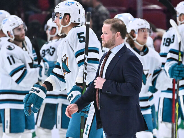 MONTREAL, CANADA - NOVEMBER 29: Assistant coach Ryan Warsofsky of the San Jose Sharks walks past his team as they celebrate a victory against the Montreal Canadiens at Centre Bell on November 29, 2022 in Montreal, Quebec, Canada. The San Jose Sharks defeated the Montreal Canadiens 4-0.