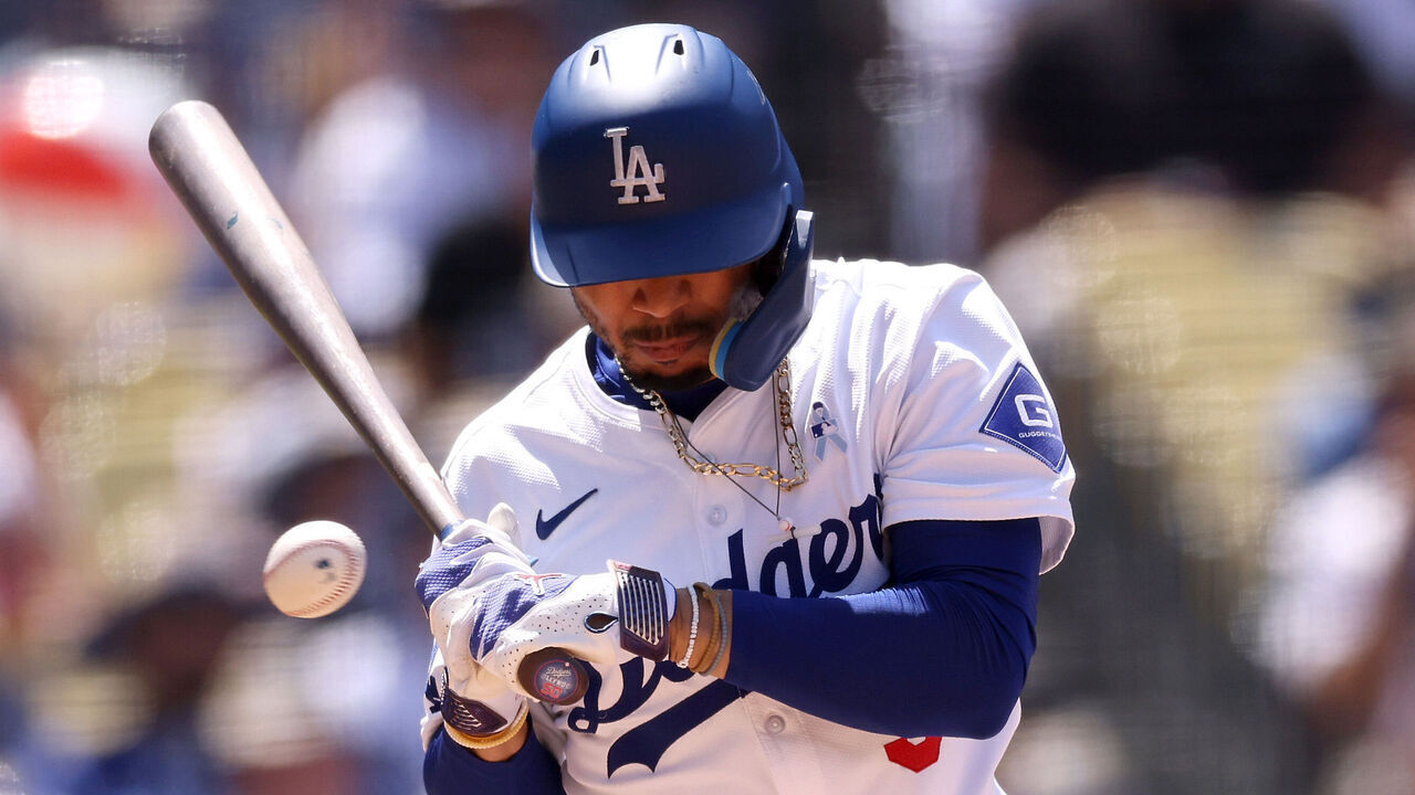 LOS ANGELES, CALIFORNIA - JUNE 16: Mookie Betts #50 of the Los Angeles Dodgers gets hit by a pitch during the seventh inning against the Kansas City Royals at Dodger Stadium on June 16, 2024 in Los Angeles, California.