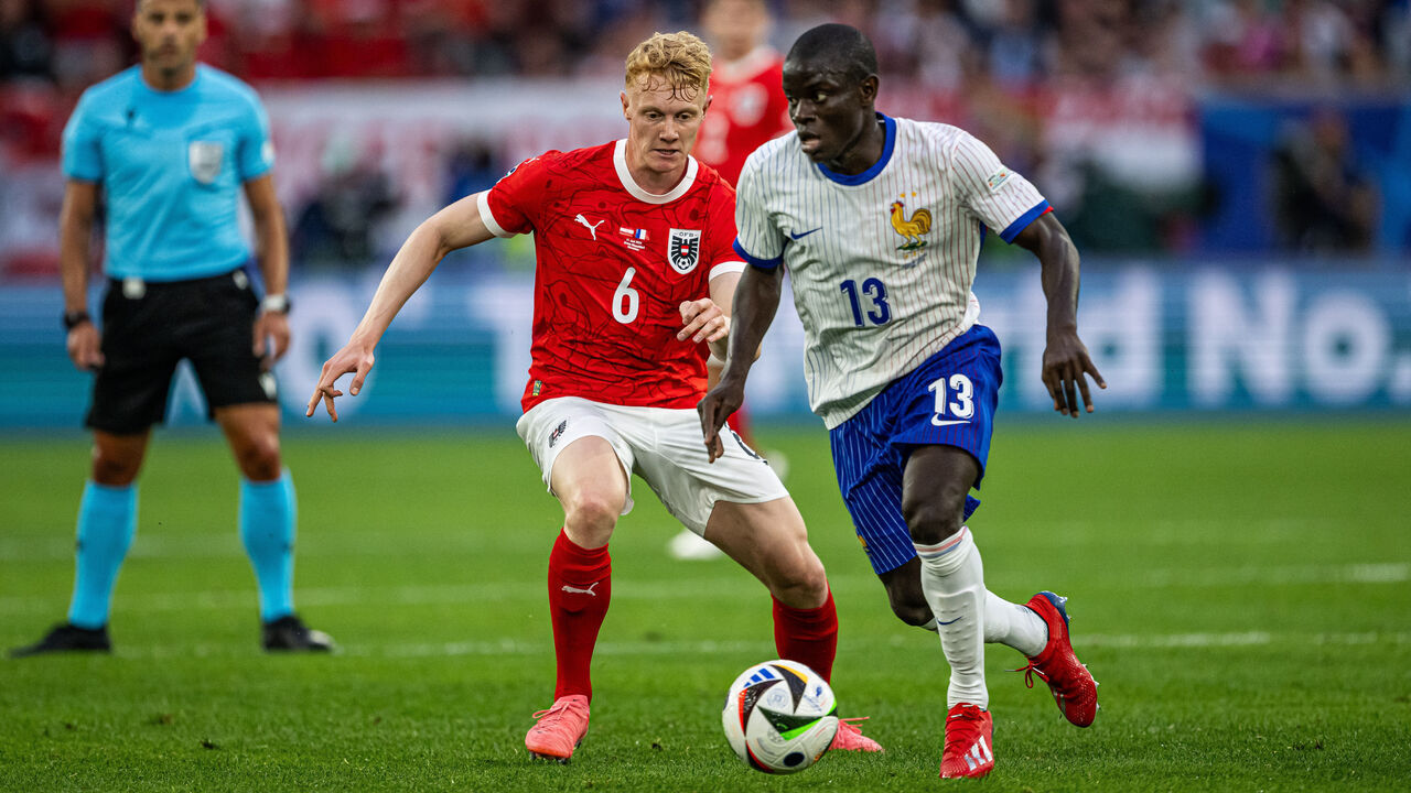 DUSSELDORF, GERMANY - JUNE 17: N'Golo Kante of France (R) is tackled by Nicolas Seiwald of Austria (L) during the UEFA EURO 2024 group stage match between Austria and France at Düsseldorf Arena on June 17, 2024 in Dusseldorf, Germany.