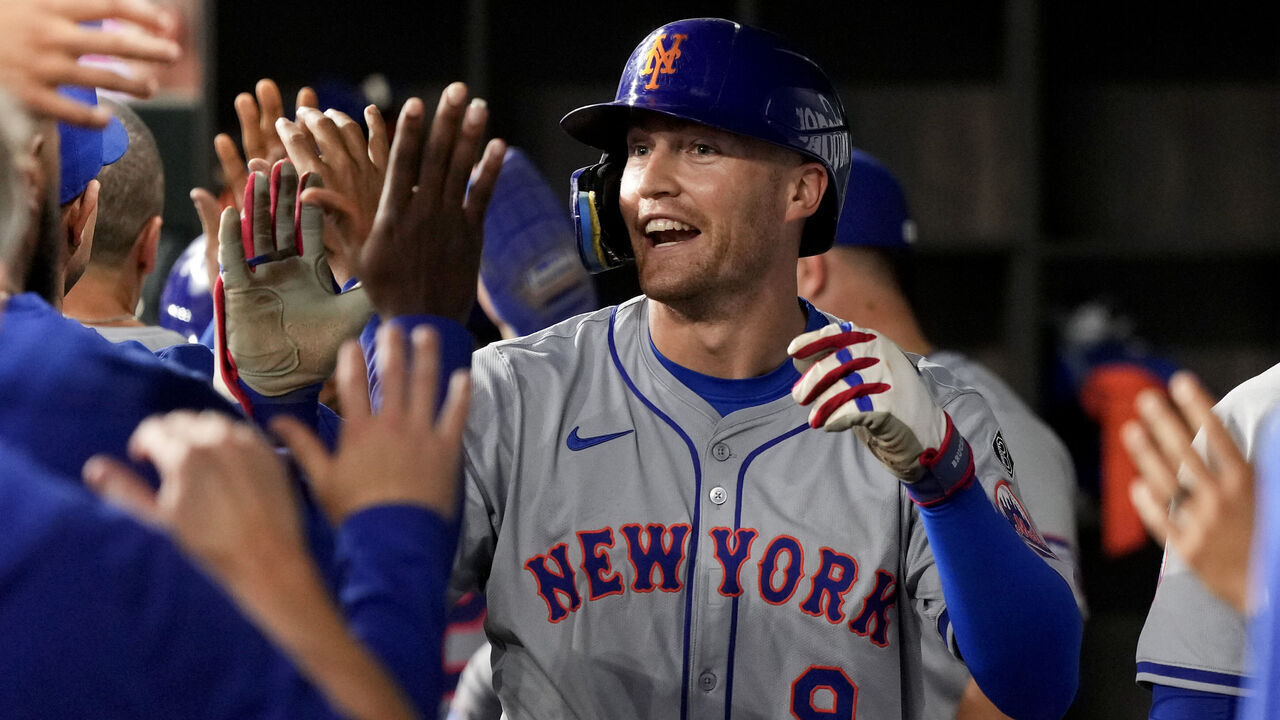 ARLINGTON, TEXAS - JUNE 17: Brandon Nimmo #9 of the New York Mets is congratulated by his teammates in the dugout after hitting a two-run home run during the fourth inning against the Texas Rangers at Globe Life Field on June 17, 2024 in Arlington, Texas.