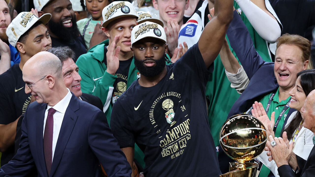 BOSTON, MASSACHUSETTS - JUNE 17: Jaylen Brown #7 of the Boston Celtics holds up the Bill Russell NBA Finals Most Valuable Player award after Boston's 106-88 win against the Dallas Mavericks in Game Five of the 2024 NBA Finals at TD Garden on June 17, 2024 in Boston, Massachusetts.