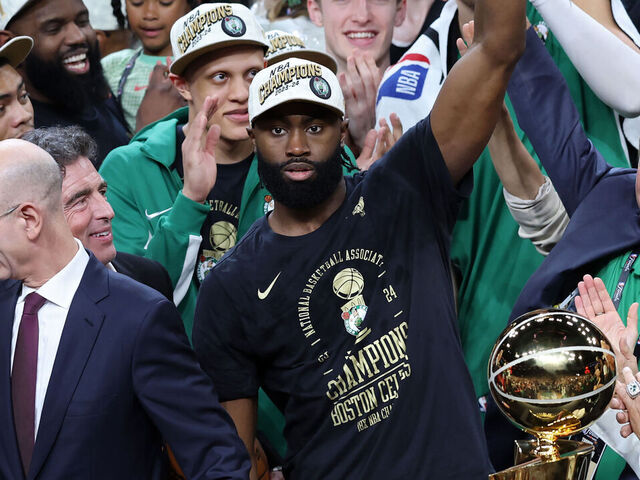 BOSTON, MASSACHUSETTS - JUNE 17: Jaylen Brown #7 of the Boston Celtics holds up the Bill Russell NBA Finals Most Valuable Player award after Boston's 106-88 win against the Dallas Mavericks in Game Five of the 2024 NBA Finals at TD Garden on June 17, 2024 in Boston, Massachusetts.