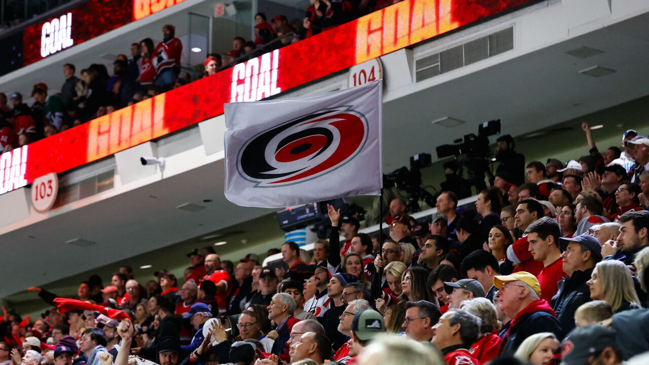 RALEIGH, NC - DECEMBER 28: Carolina Hurricanes Storm Crew waves a flag during the third period of the game against Carolina Hurricanes at PNC Arena on December 28, 2023 in Raleigh, North Carolina. Hurricanes defeat Montreal 5-3.