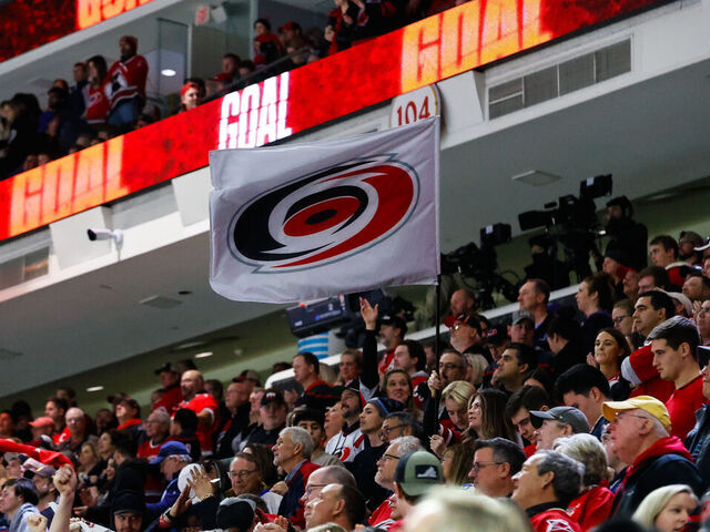 RALEIGH, NC - DECEMBER 28: Carolina Hurricanes Storm Crew waves a flag during the third period of the game against Carolina Hurricanes at PNC Arena on December 28, 2023 in Raleigh, North Carolina. Hurricanes defeat Montreal 5-3.