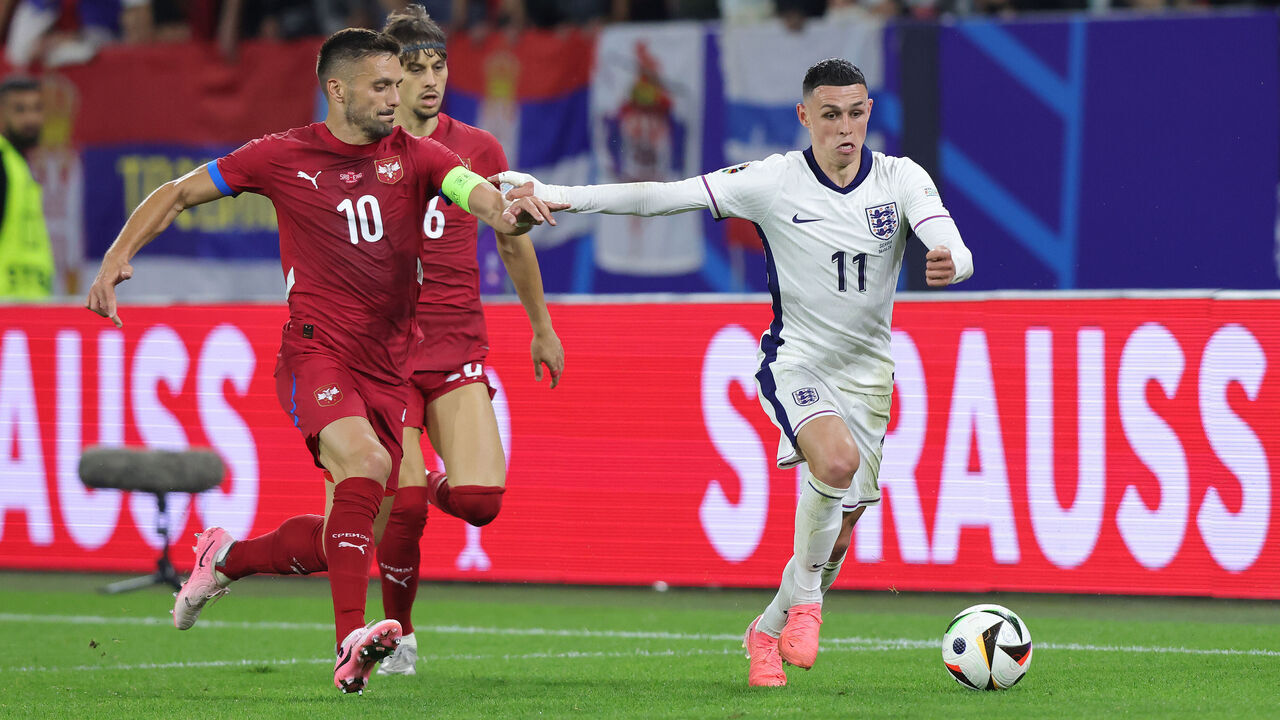 GELSENKIRCHEN, GERMANY - JUNE 16: Dusan Tadic of Serbia (L) and Phil Foden of England compete for the ball during the UEFA EURO 2024 group stage match between Serbia and England at Arena AufSchalke on June 16, 2024 in Gelsenkirchen, Germany.