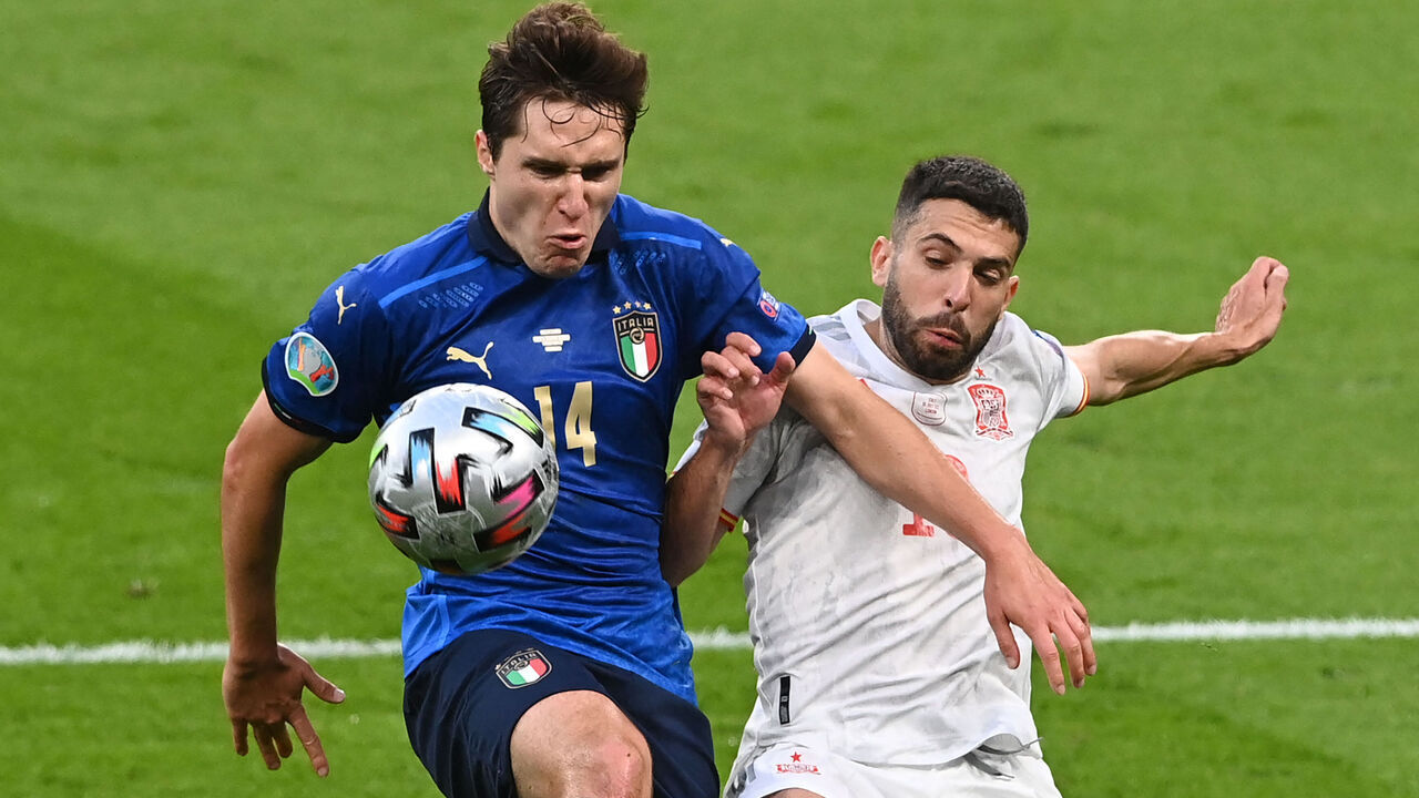 TOPSHOT - Italy's midfielder Federico Chiesa (L) and Spain's defender Jordi Alba vie for the ball during the UEFA EURO 2020 semi-final football match between Italy and Spain at Wembley Stadium in London on July 6, 2021.