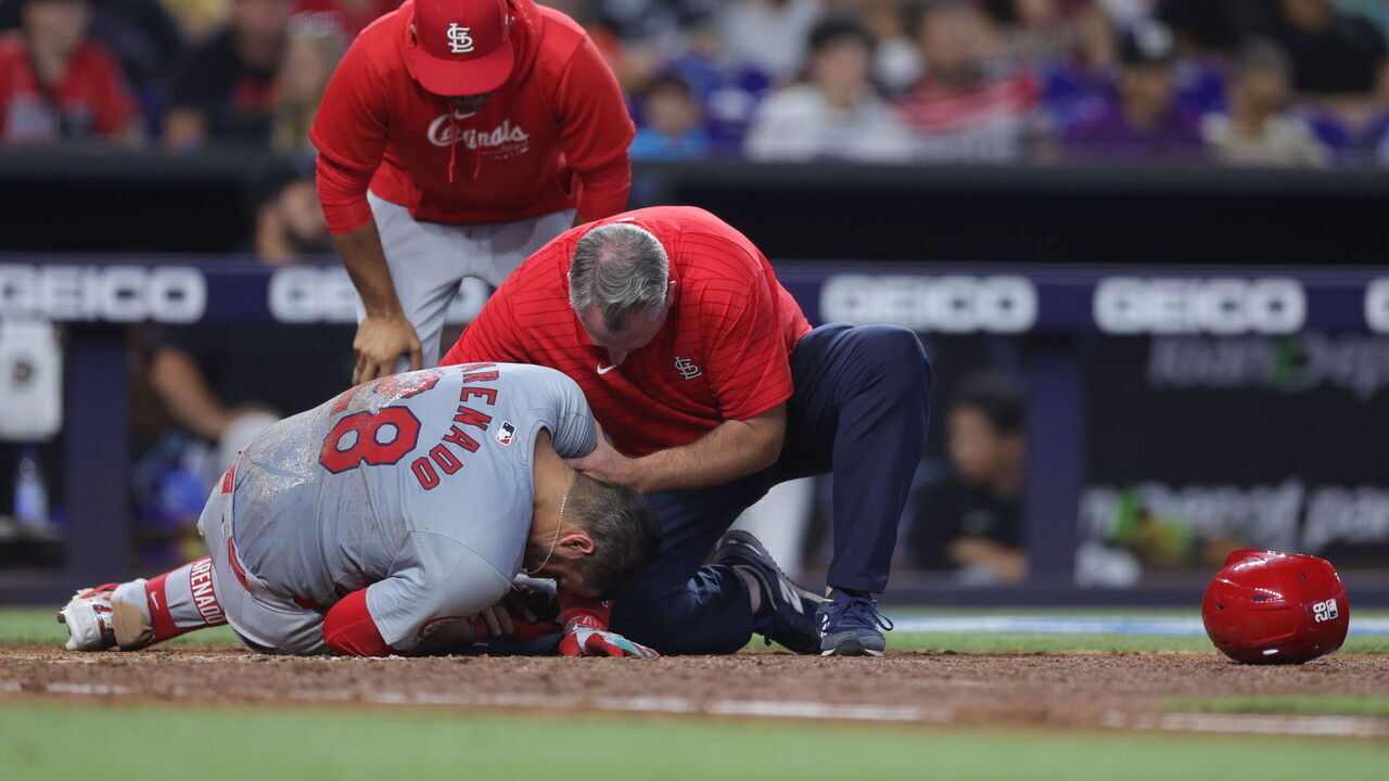 MIAMI, FLORIDA - JUNE 19: Nolan Arenado #28 of the St. Louis Cardinals is hit by pitch from Huascar Brazoban of the Miami Marlins during the eighth inning at loanDepot park on June 19, 2024 in Miami, Florida.
