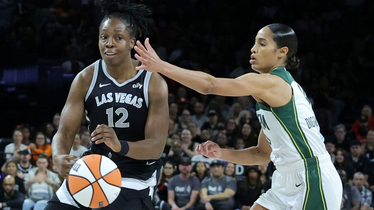 LAS VEGAS, NEVADA - JUNE 19: Chelsea Gray #12 of the Las Vegas Aces passes against Skylar Diggins-Smith #4 of the Seattle Storm for Gray's 1,500th career assist in the first quarter of their game at Michelob ULTRA Arena on June 19, 2024 in Las Vegas, Nevada. The Aces defeated the Storm 94-83.
