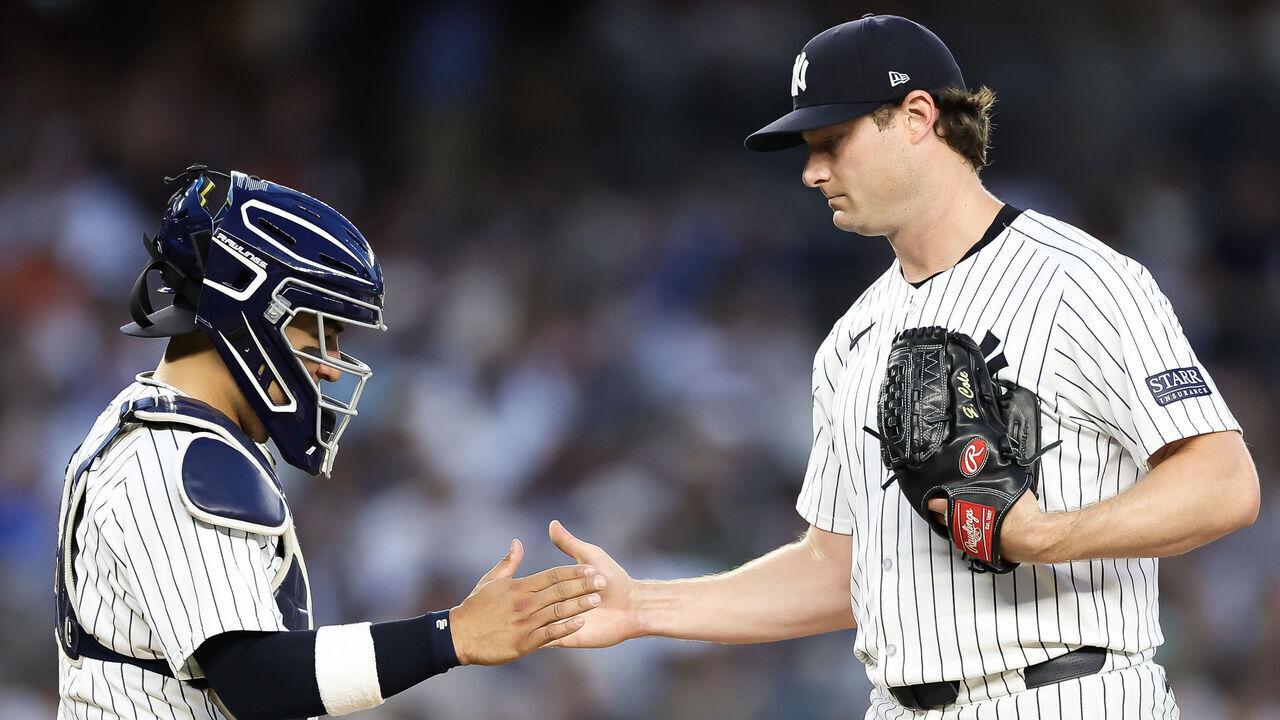 NEW YORK, NEW YORK - JUNE 19: Jose Trevino #39 of the New York Yankees shakes hands with with Gerrit Cole #45 as he leaves the game against the Baltimore Orioles during the fifth inning at Yankee Stadium on June 19, 2024 in the Bronx borough of New York City.