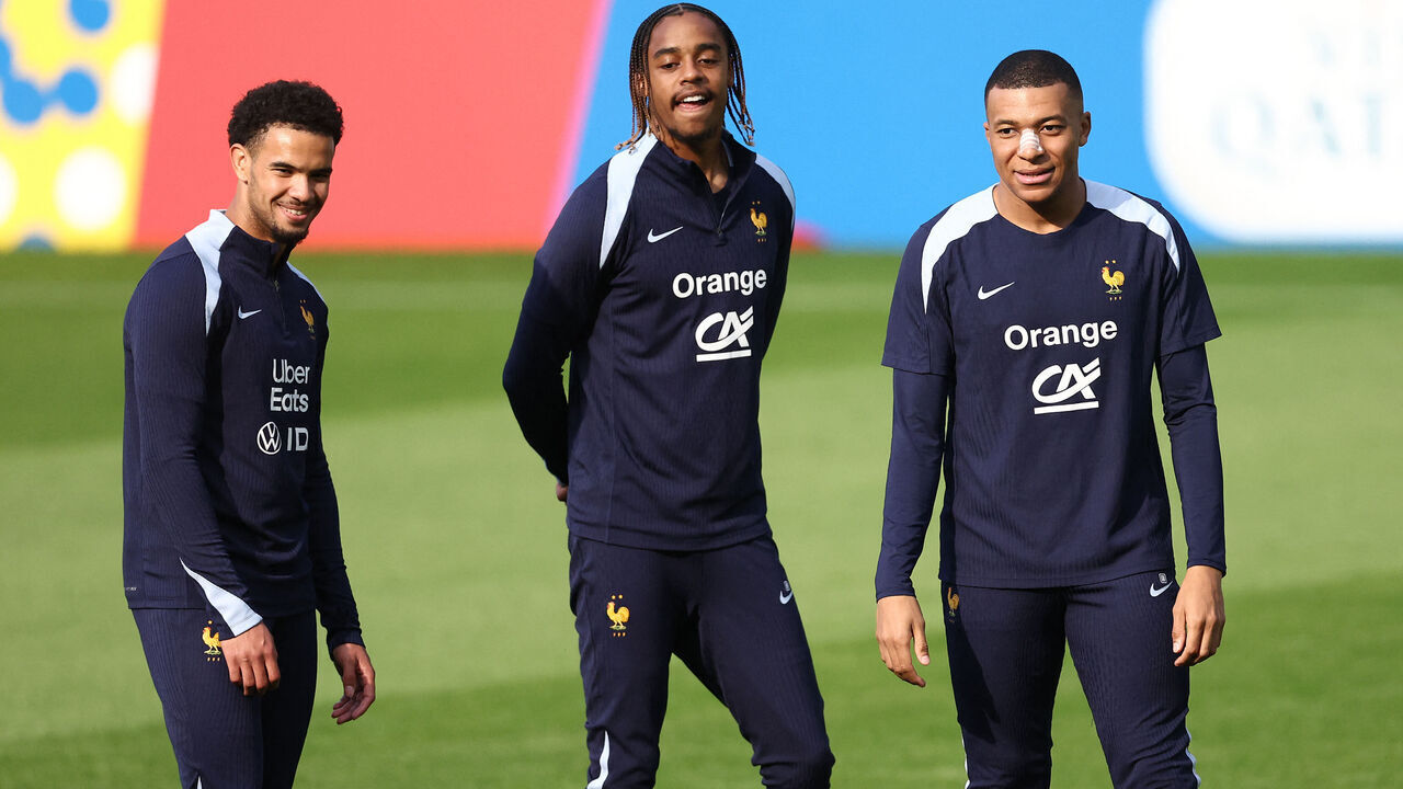 France's forward #10 Kylian Mbappe (R), wearing a band-aid after breaking his nose during his country's opening win against Austria, France's midfielder 18 Warren Zaire-Emery (L) and France's forward #25 Bradley Barcola attend a training session within the UEFA Euro 2024 Football Championship, at the Home Deluxe Arena Stadium in Paderborn, western Germany, on June 19, 2024. Mbappe underwent tests at a hospital in Duesseldorf before rejoining the France squad at their base in Paderborn.