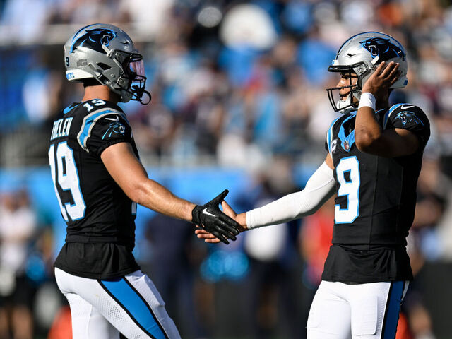 CHARLOTTE, NORTH CAROLINA - OCTOBER 29: Adam Thielen #19 of the Carolina Panthers high fives Bryce Young #9 of the Carolina Panthers during the fourth quarter of the game against the Houston Texans at Bank of America Stadium on October 29, 2023 in Charlotte, North Carolina.