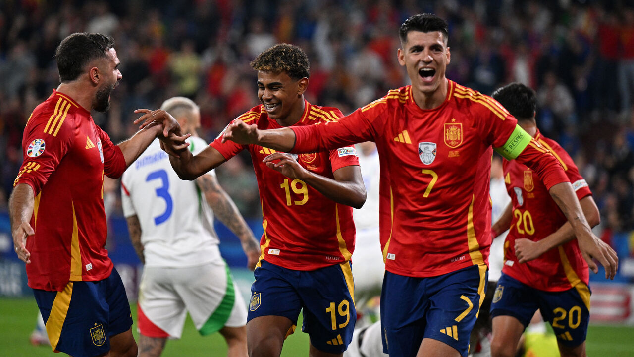 Spain's defender #02 Dani Carvajal (L), Spain's forward #19 Lamine Yamal (2L) and Spain's forward #07 Alvaro Morata (R) celebrate after Italy's defender #05 Riccardo Calafiori scored an own goal during the UEFA Euro 2024 Group B football match between Spain and Italy at the Arena AufSchalke in Gelsenkirchen on June 20, 2024.