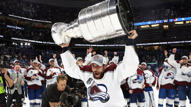 TAMPA, FLORIDA - JUNE 26: Andrew Cogliano #11 of the Colorado Avalanche carries the Stanley Cup following the series winning victory over the Tampa Bay Lightning in Game Six of the 2022 NHL Stanley Cup Final at Amalie Arena on June 26, 2022 in Tampa, Florida.