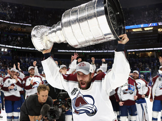 TAMPA, FLORIDA - JUNE 26: Andrew Cogliano #11 of the Colorado Avalanche carries the Stanley Cup following the series winning victory over the Tampa Bay Lightning in Game Six of the 2022 NHL Stanley Cup Final at Amalie Arena on June 26, 2022 in Tampa, Florida.