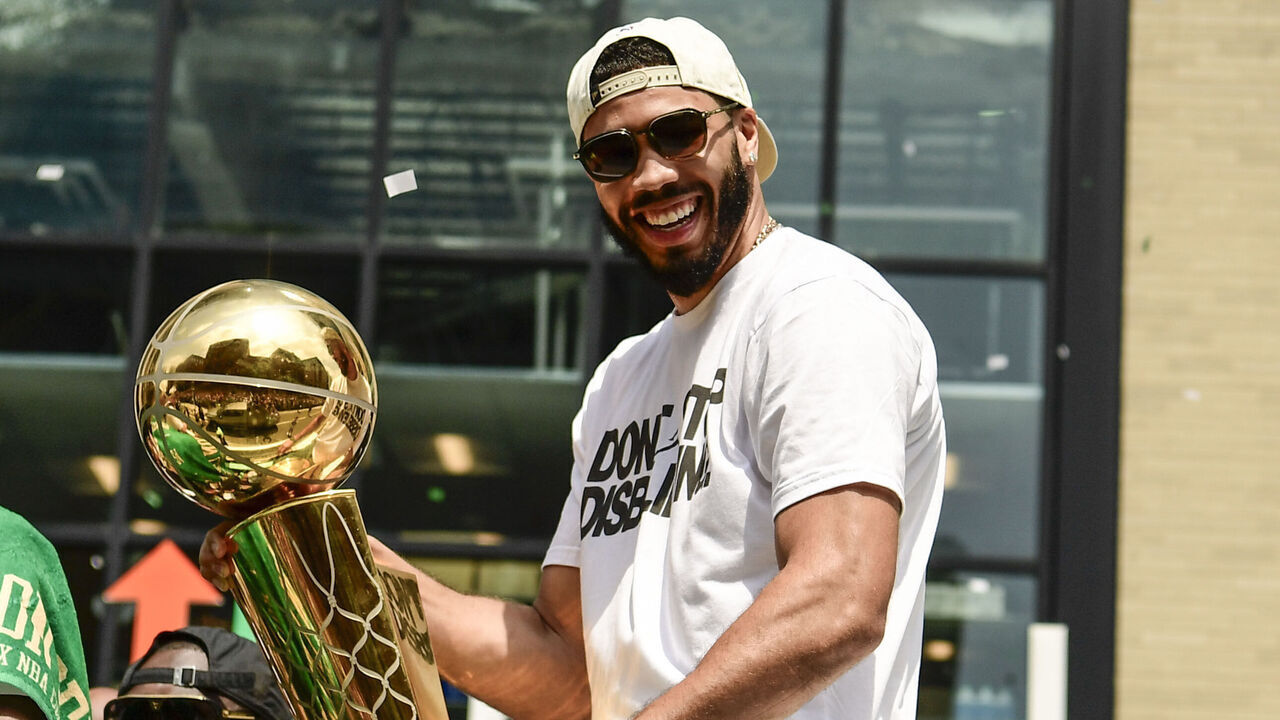 BOSTON, MASSACHUSETTS - JUNE 21: Jason Tatum #0 of the Boston Celtics reacts as he holds the Larry O'Brien Championship Trophy during the 2024 Boston Celtics championship parade following their 2024 NBA Finals win on June 21, 2024 in Boston, Massachusetts.
